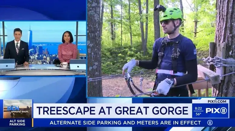 Screenshot from a promotional video that was featured in the news, showing various outdoor activities at TreEscape Aerial Adventure Park in Vernon, NJ, featuring rope courses, zip lining, and guests navigating treetop obstacles.