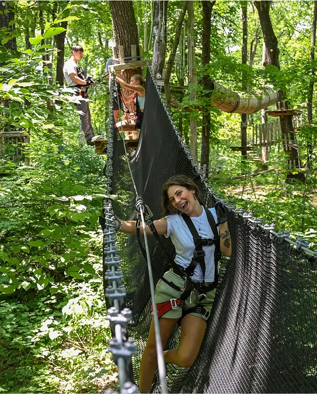 Group of students enjoying a school field trip at TreEscape Aerial Adventure Park in Vernon, NJ, participating in outdoor climbing and team-building activities.