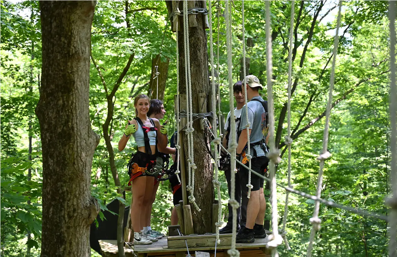 Group of students enjoying a fun and adventurous day at TreEscape Park, a youth camp in Vernon, NJ, engaging in outdoor activities and team-building exercises.