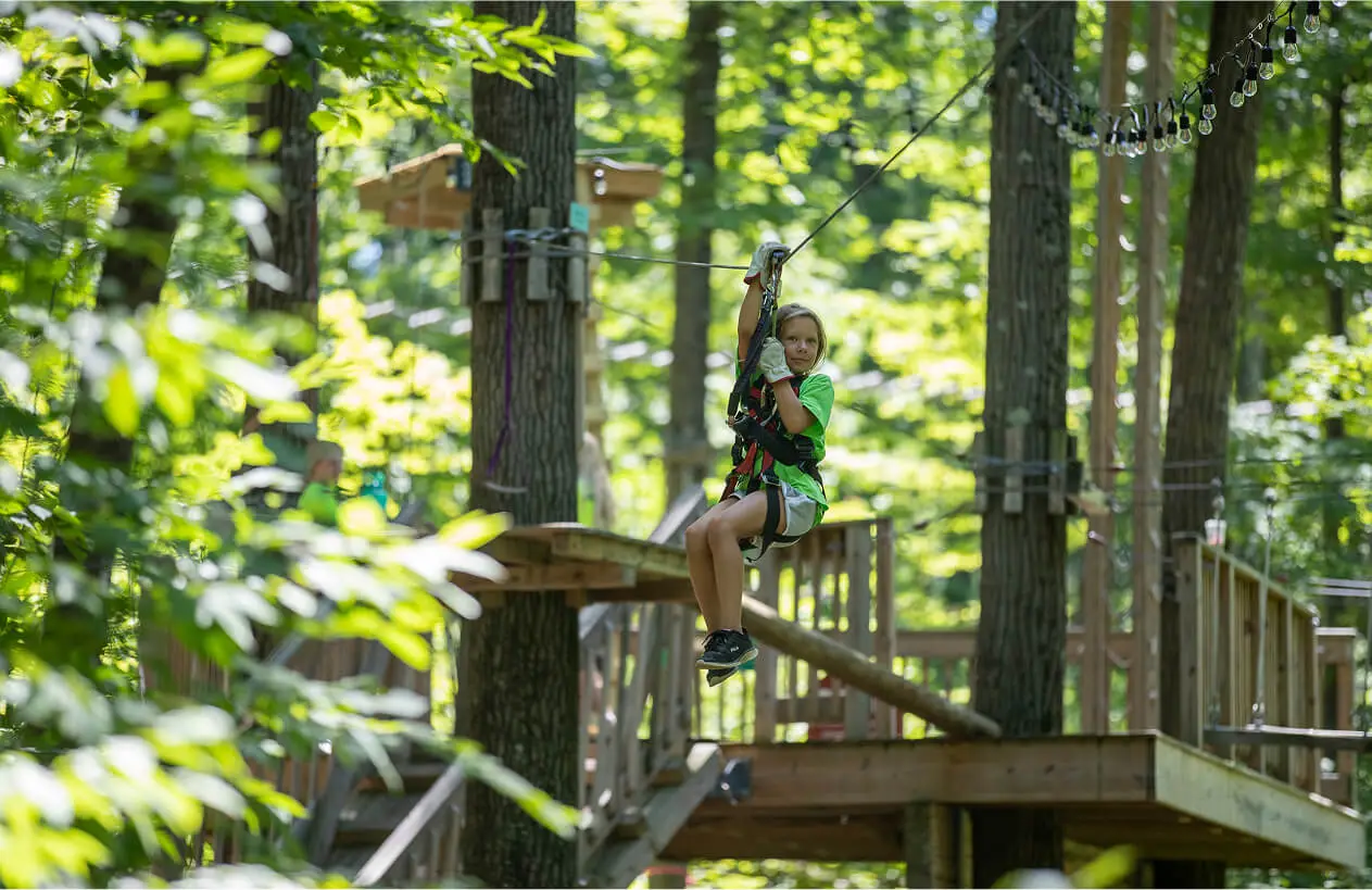 Young girl on the zip line at TreEscape Aerial Adventure Park, Vernon, New Jersey.