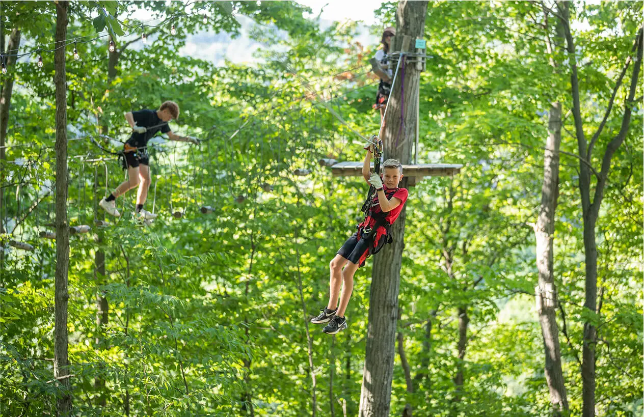 Kids on the zip line at TreEscape Aerial Adventure Park, Vernon, New Jersey. Ziplining NJ