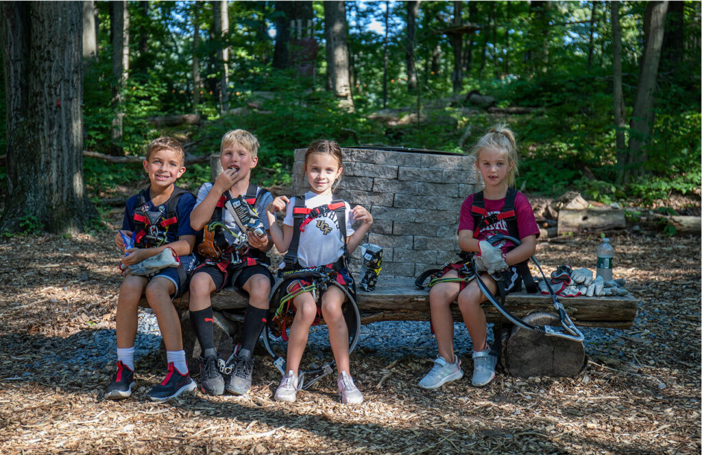 Kids fully geared up and ready for adventure at TreEscape Park in Vernon, NJ, excited to take on the park's outdoor challenges and activities.