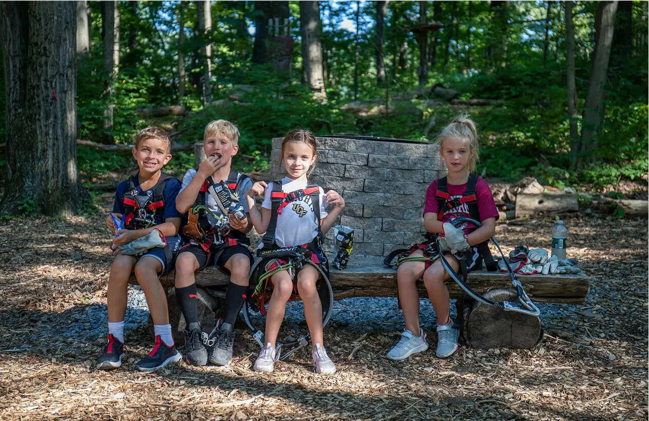 Kids fully geared up and ready for adventure at TreEscape Park in Vernon, NJ, excited to take on the park's outdoor challenges and activities.