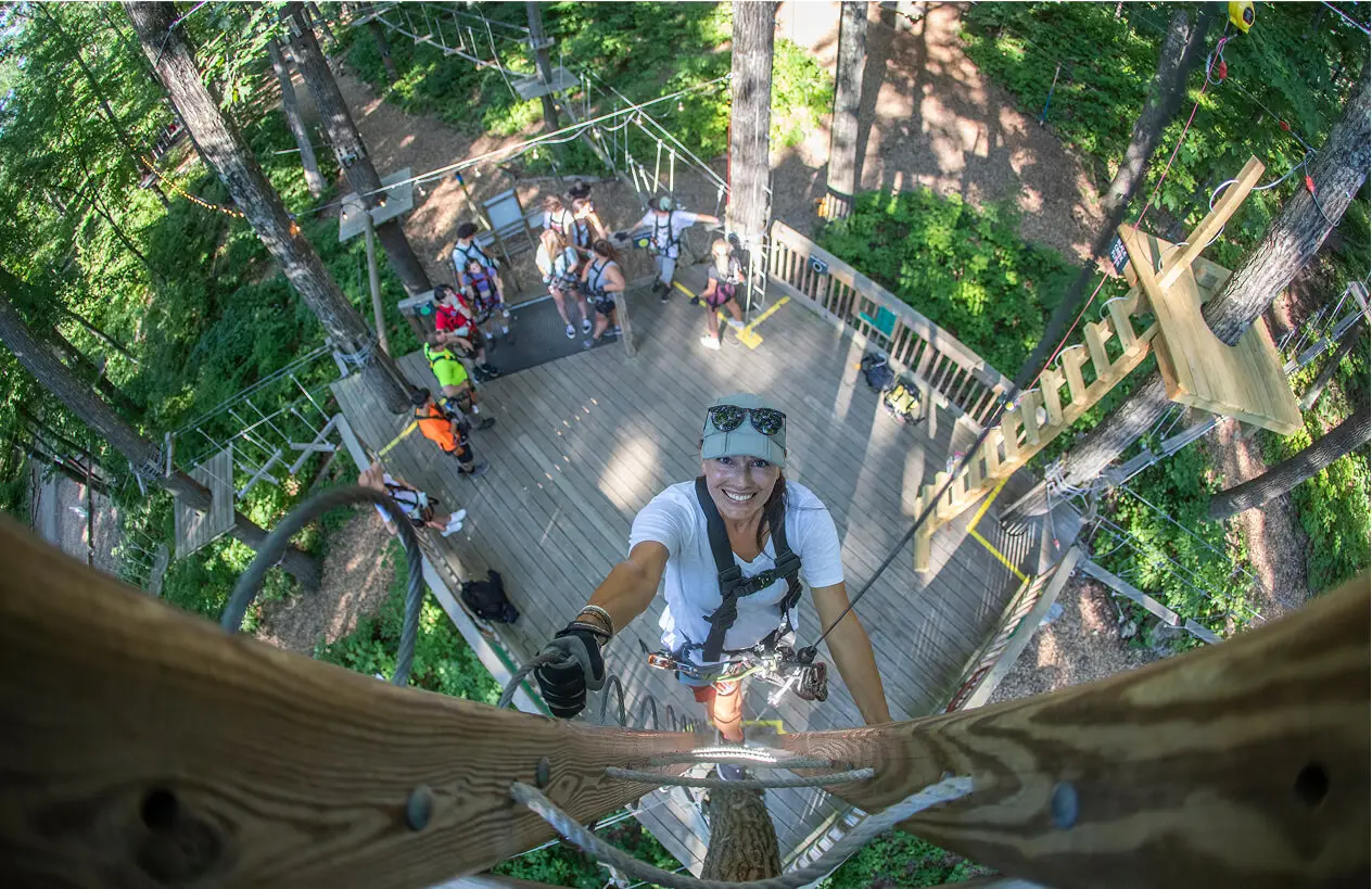 Bird's-eye view of a group of teenagers at TreEscape Park in Vernon, NJ, enjoying outdoor activities and exploring the park from a unique perspective.