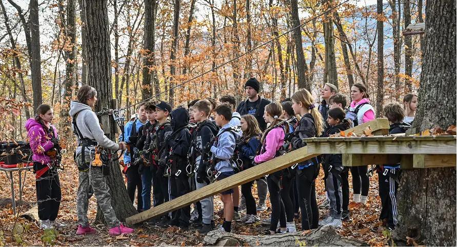 Students and teachers on a school field trip at TreEscape Park in Vernon, NJ, enjoying a day of outdoor exploration, team-building activities, and adventure in nature.