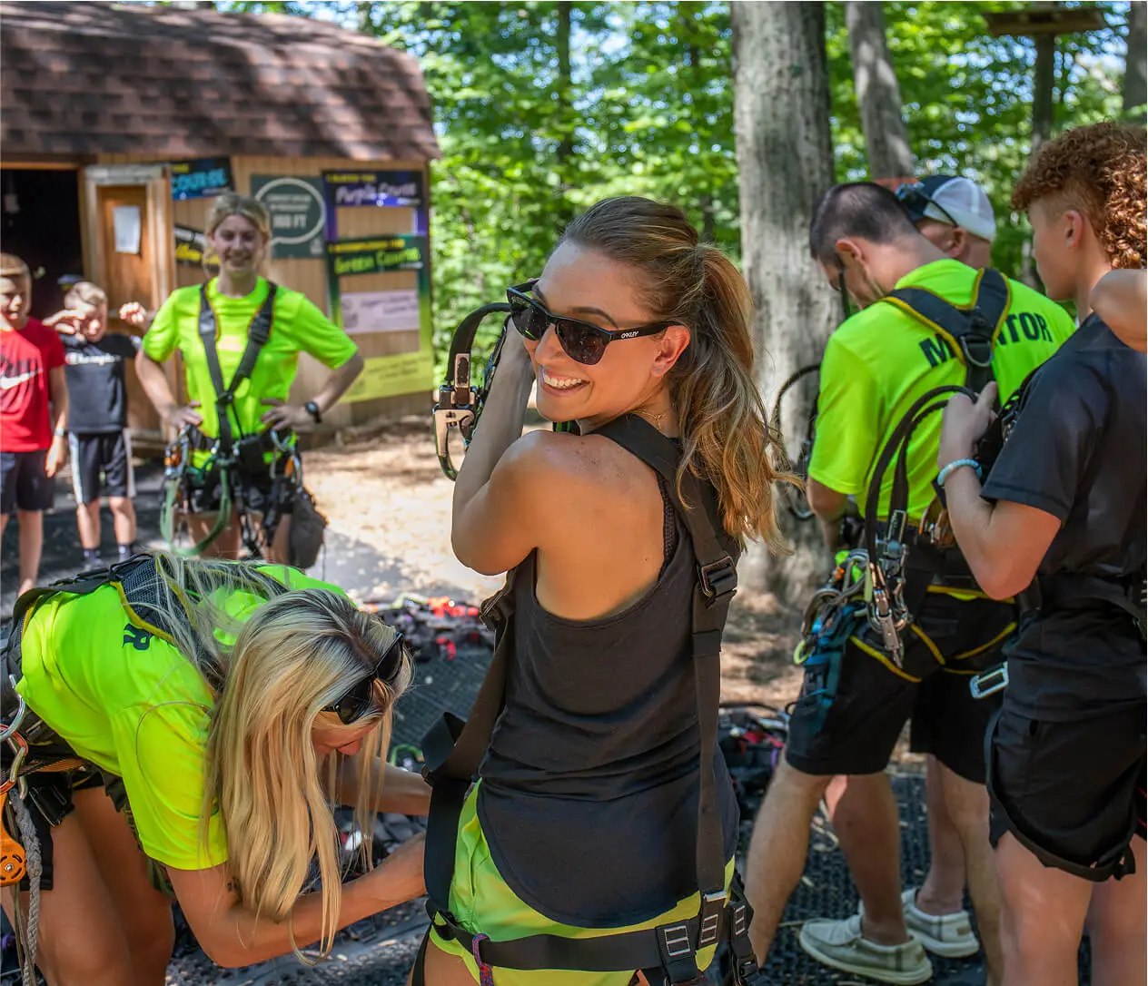 Young people gearing up and preparing for an adventure at TreEscape Park in Vernon, NJ, excited and ready to take on the outdoor activities ahead.