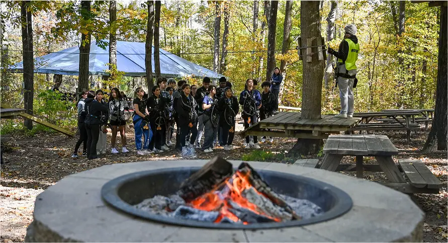 Kids gathered around a campfire at TreEscape Park in Vernon, NJ, enjoying a cozy evening.