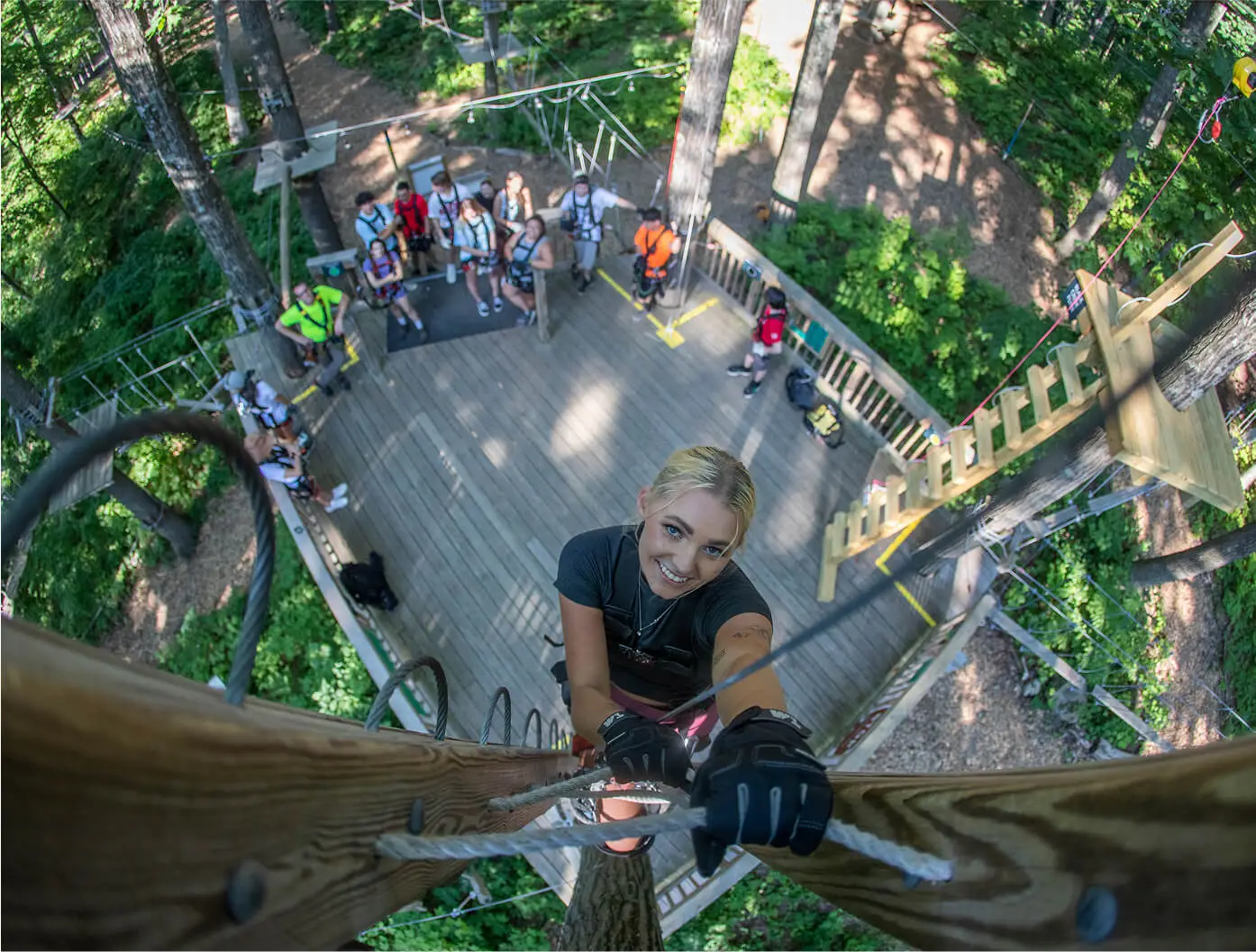 Bird's-eye view of a group of teenagers at TreEscape Park in Vernon, NJ, enjoying outdoor activities and exploring the park from a unique perspective.