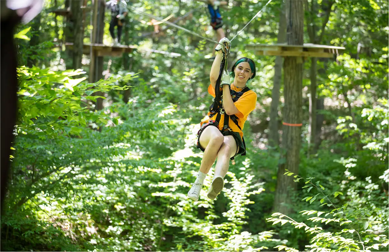 Girl on the zip line at TreEscape Aerial Adventure Park, Vernon, New Jersey.