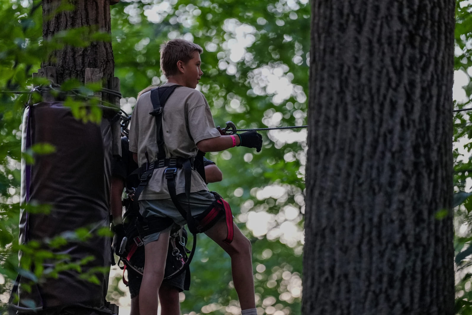 young person prepared for a ropes course adventure at TReEscape